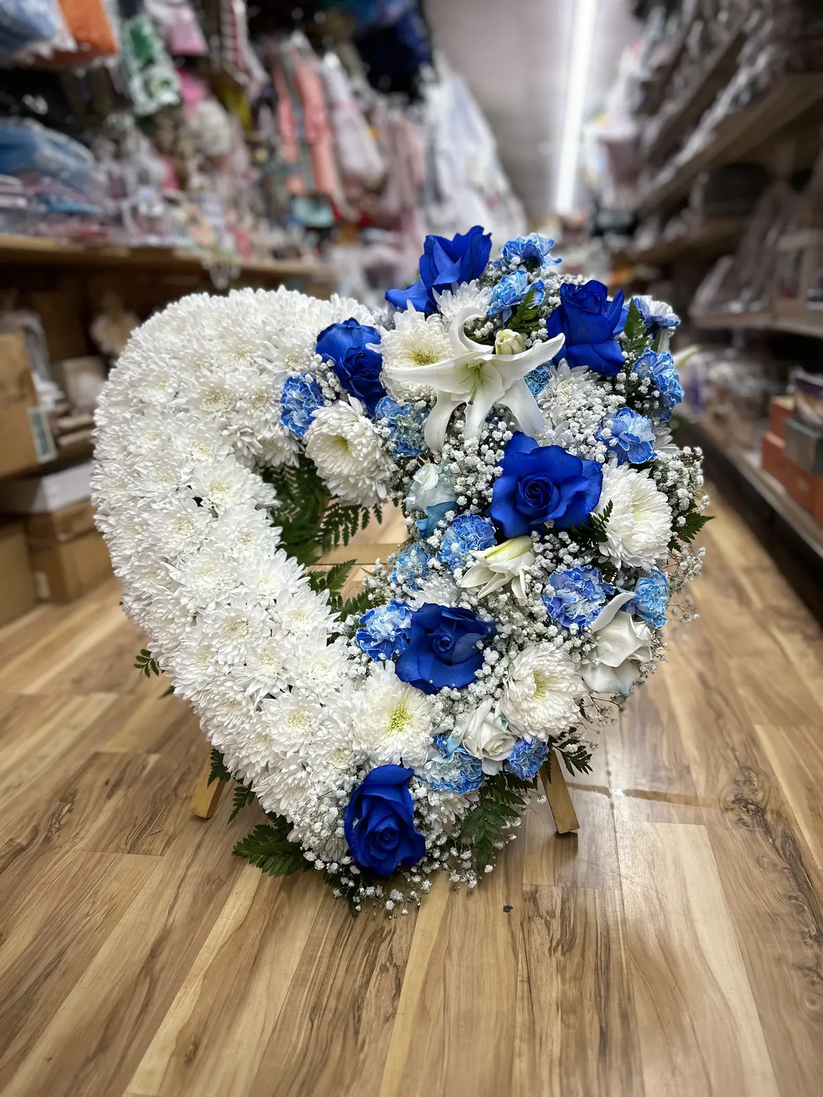 Blue and white heart-shaped floral tribute