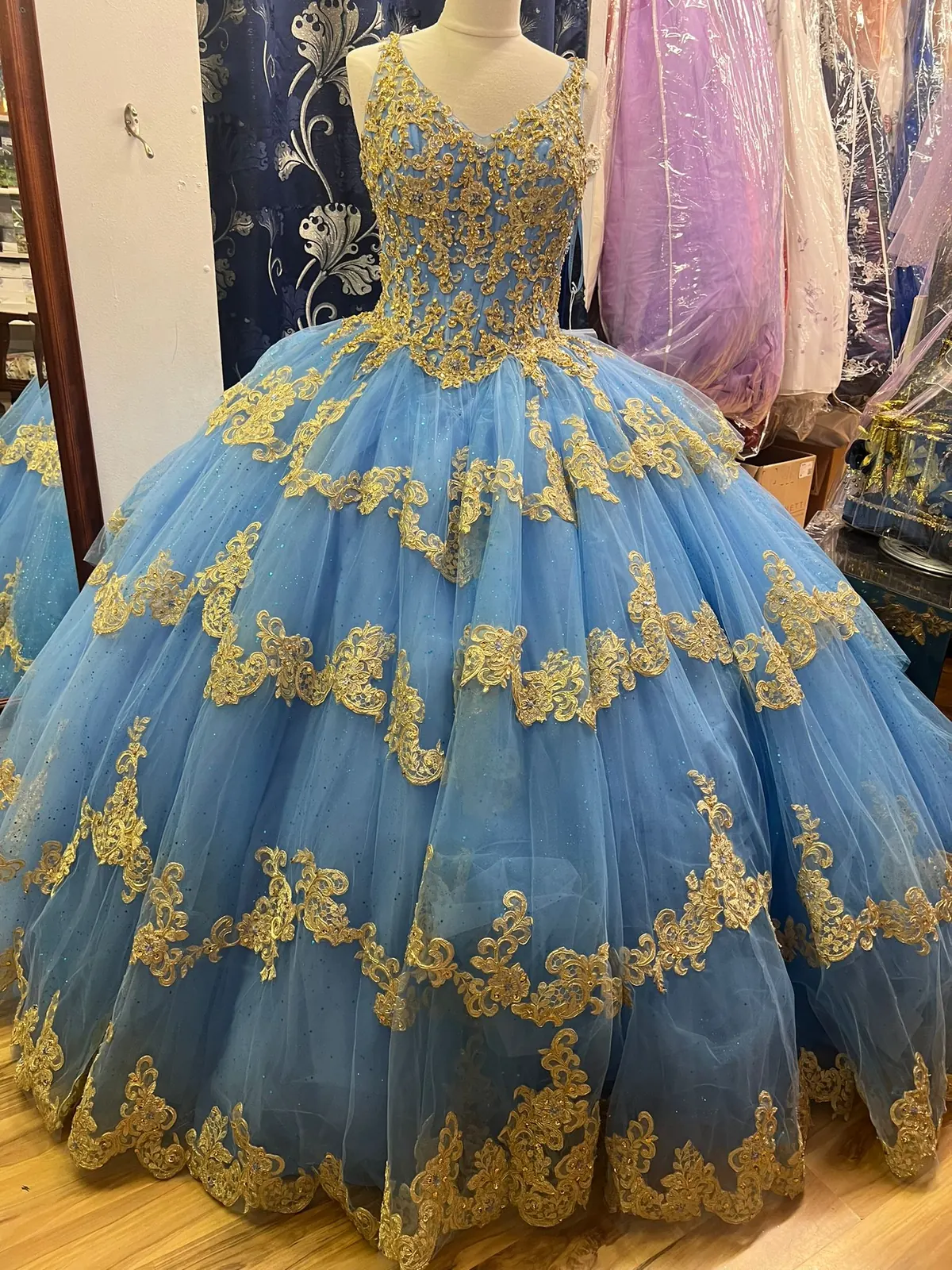 Sky blue quinceañera ball gown with gold lace appliqué