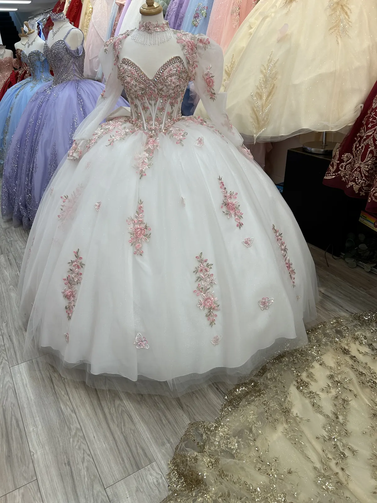 White quinceañera gown with pink flowers and train