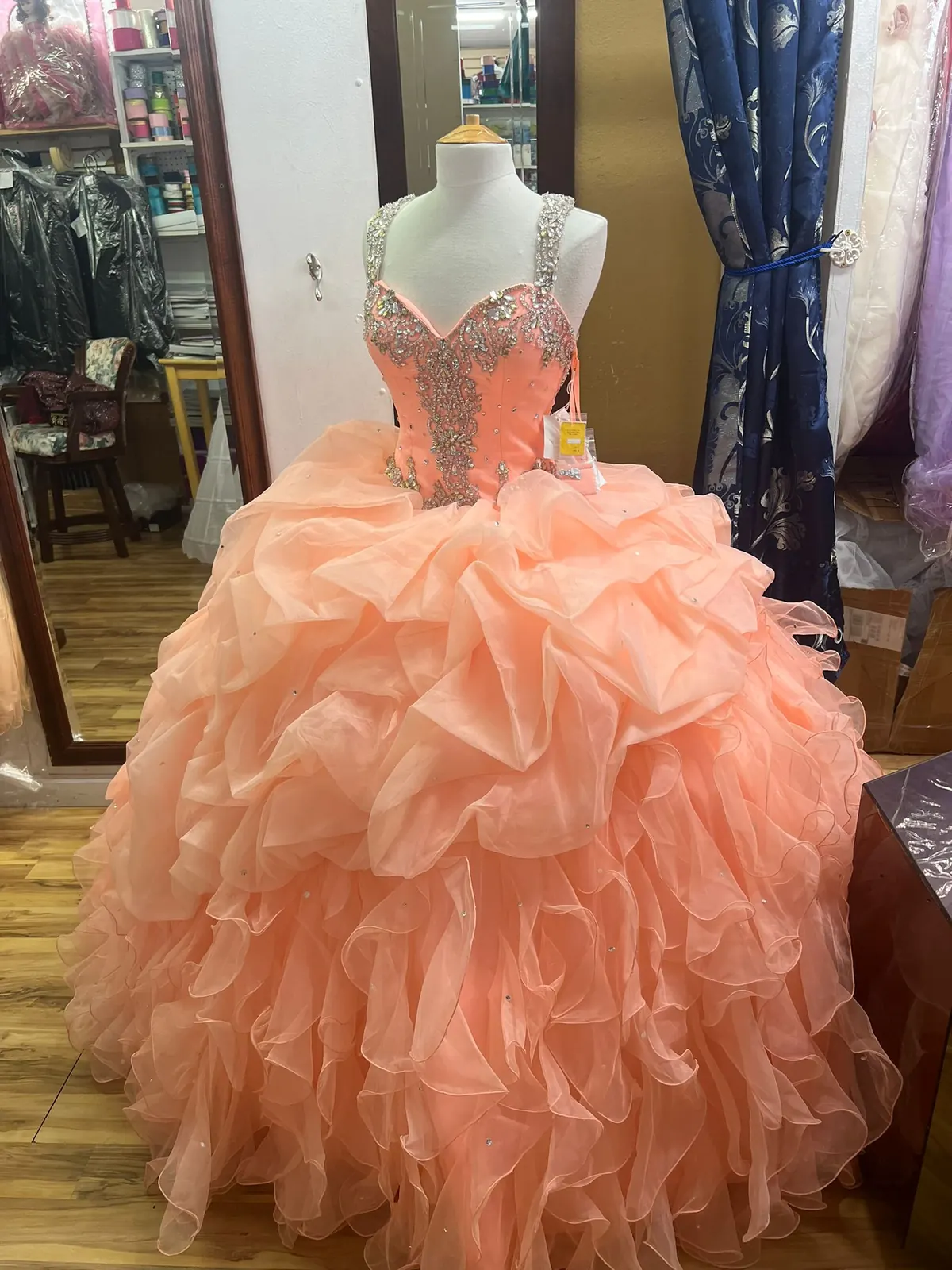 Peach ruffled quinceañera ball gown