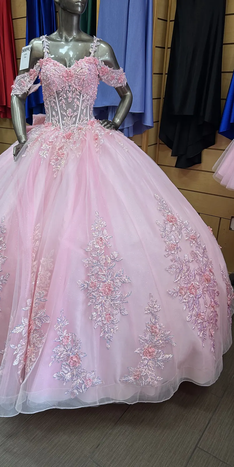 Pink quinceañera ball gown with floral appliqué